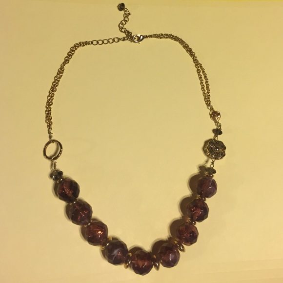 Beaded necklace with gold flower and leaf accent