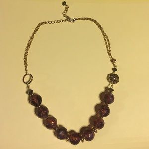 Beaded necklace with gold flower and leaf accent