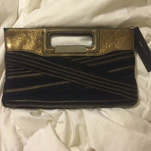 BCBG MAXAZRIA
Urban Rock Cutout Zipper clutch