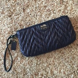 Coach navy blue wristlet is a sassy but chic purse