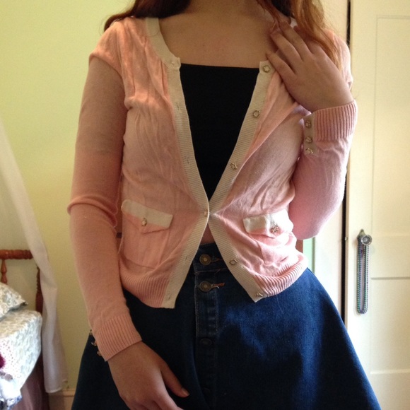 Pink cardigan with white trim and floral buttons