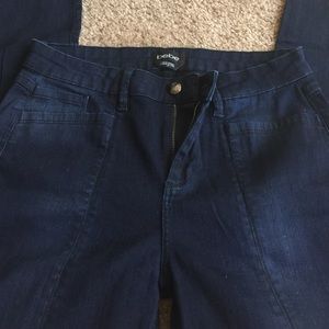 Skinny blue jeans with slit in the front.