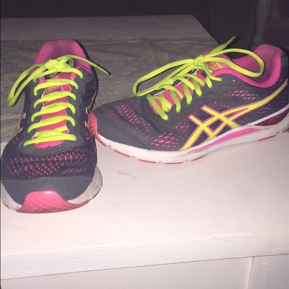 Pink, grey, and yellow aasics tennis shoes