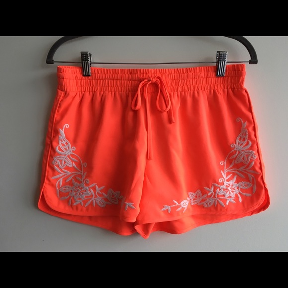 Bright coral shorts with floral embroidery