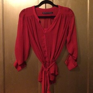 Sheer red button down blouse with belted waist