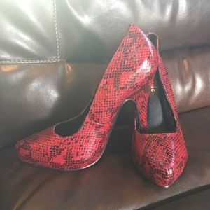 Red snakeskin heels.