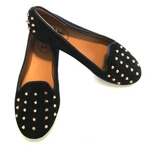 Black loafers with gold spikes