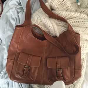 tan bag with pockets and blue design on the inside
