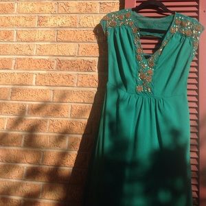 Mid-length ANTHRO with back cutout and beading.
