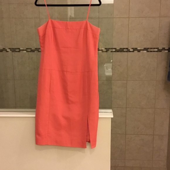 Coral thin strap dress with slit in front.
