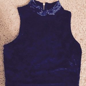 Sleeveless velour crop top with back zipper.