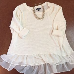 American Eagle cream knit top with ruffles.