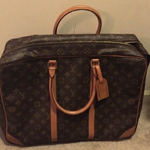 Louis Vuitton luggage with a tag