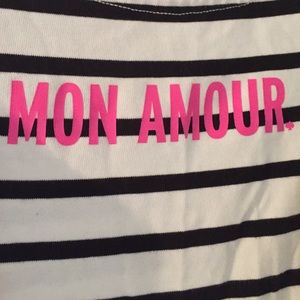 Black and white striped shirt with pink lettering