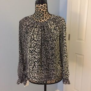 Jennifer Lopez open-back cheetah print blouse