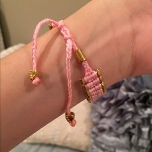 Pink and gold bracelet with bones and paws