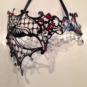 Masquerade mask. Black filigree with red crystals