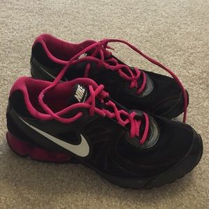 Pink and black nike running shoes