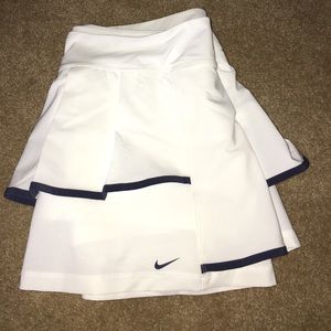 NIKE DRI FIT ATHLETIC SKIRT WITH BUILT IN SHORTS.