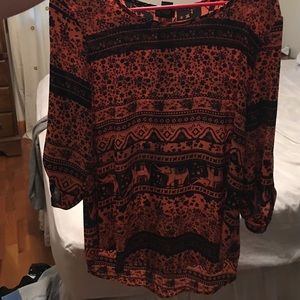 Pinkish/black elephant print shirt. Longer back.