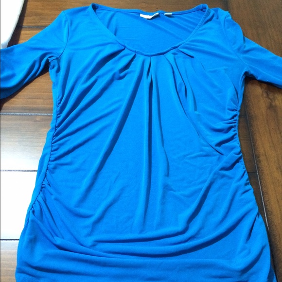 Stretchy 3/4 inch sleeves with rouching on sides.