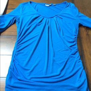 Stretchy 3/4 inch sleeves with rouching on sides.