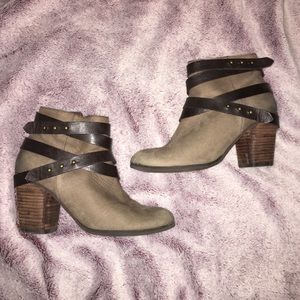 Brown suede ankle boots with leather straps.