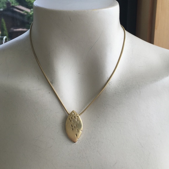 Gold colored necklace with oval pendant