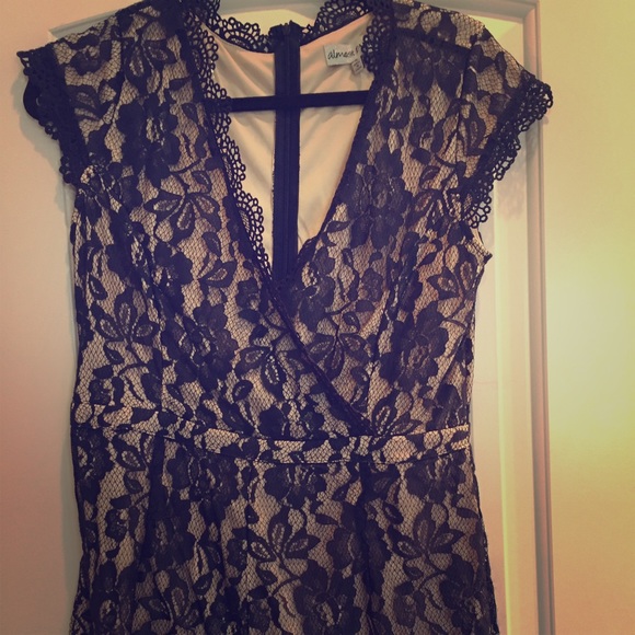 Super cute nude and navy lace romper.