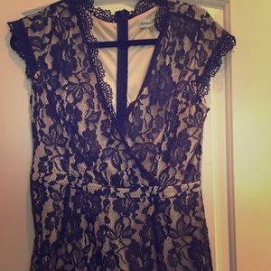 Super cute nude and navy lace romper.