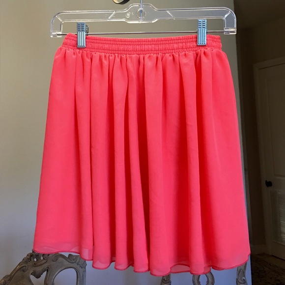 Bright melon colored mini flowy skirt