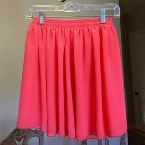 Bright melon colored mini flowy skirt