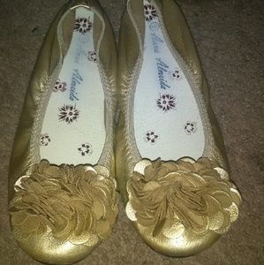 Gold ballerina shoes.
