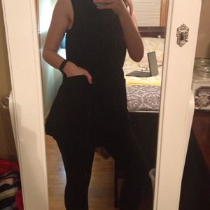 Long black sleeveless trench with pockets.