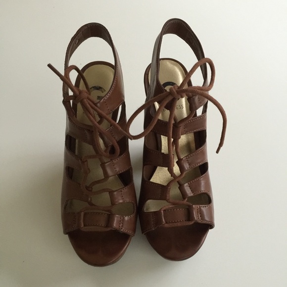 Brown Lace up heels with a wooden wedge.