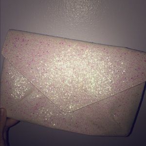 White shimmer hand purse.