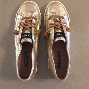 Gold Sperry sneakers. They have never been worn.