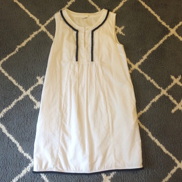 Kids white linen dress with navy pom pom trim