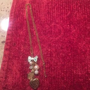 Long Alice in Wonderland style necklace.