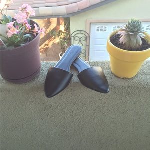 Black vegan leather pointed toe mules.