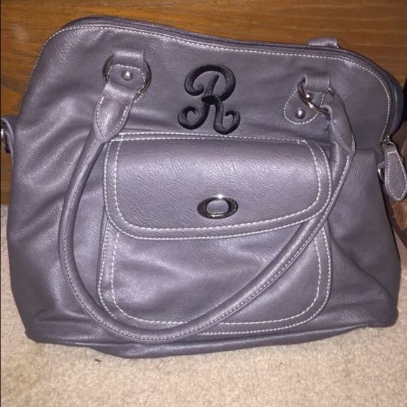 Gray purse with black R embroidered on it