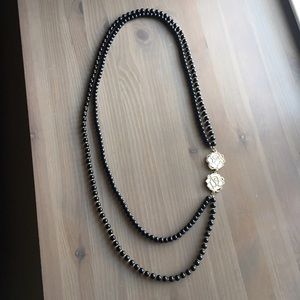 Long beaded asymmetrical necklace with gold roses