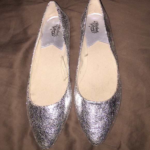 pointed toe crinkled metallic silver slip ons.