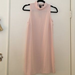 Pale pink shift dress.
