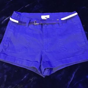 Blue shorts with blue and white leather belt.