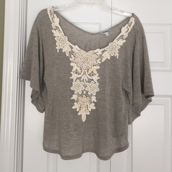 Dolman short sleeve top w/ floral appliqué.