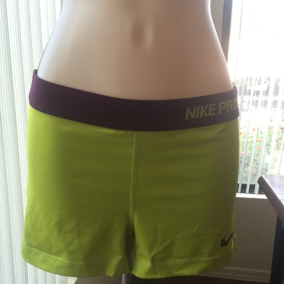 Size medium yellow and purple Nike pro shorts