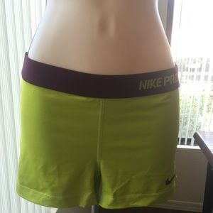Size medium yellow and purple Nike pro shorts