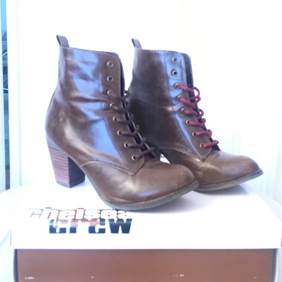 Brown lace up, heeled boots, rise above ankle.