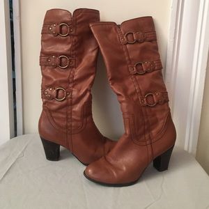 Brown high rise heeled boots.